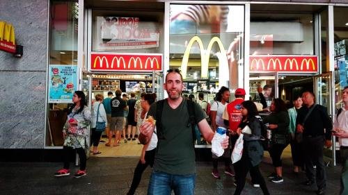 Paulo eating a Big Mac in Times Square, NY